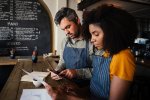 Two people analyzing social media data