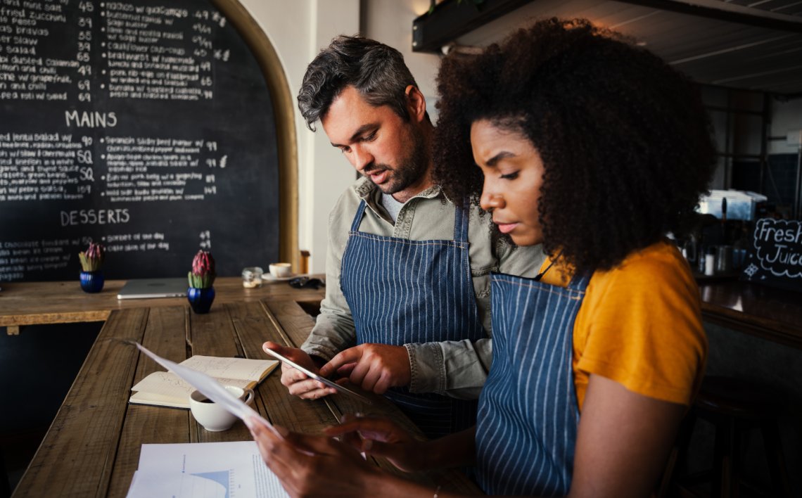 Two people analyzing social media data